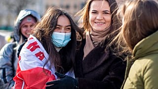 In this Saturday, March 20, 2021 file photo, Belarus opposition leader Sviatlana Tsikhanouskaya, right, poses for photos with protesters. 