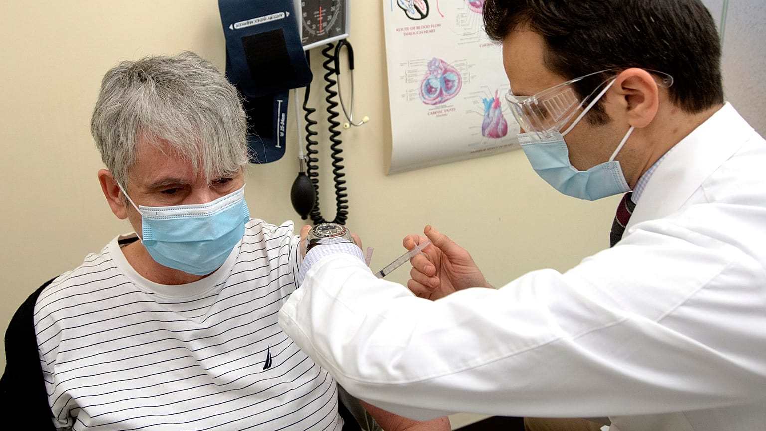 Nicole Picard receives a dose of the Moderna COVID-19 vaccine from pharmacist Nabil Chikh as pharmacies begin administering COVID-19 vaccinations Monday, March 22, 2021.