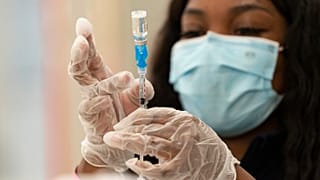 a health worker loads syringes with the vaccine on the first day of the Johnson & Johnson vaccine being made available to residents in Los Angeles, California.