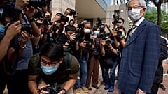 Pro-democracy lawmaker Martin Lee, right, arrives at a court in Hong Kong Thursday, April 1, 2021.