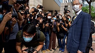 Pro-democracy lawmaker Martin Lee, right, arrives at a court in Hong Kong Thursday, April 1, 2021.