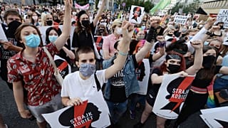 Protesters with a banner reading "Women's Strike" in a rally against Polish government