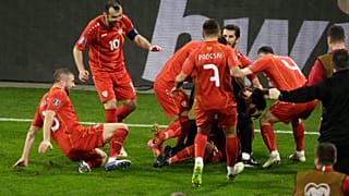North Macedonia's Eljif Elmas, not seen in the frame, celebrates with his teammates after scoring his side's second goal during the group J qualifying game agaist Germany