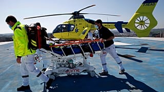 Medical workers bring an emergency arrival on the rooftop of the Amiens Picardie hospital, March 30, 2021 in Amiens, France.