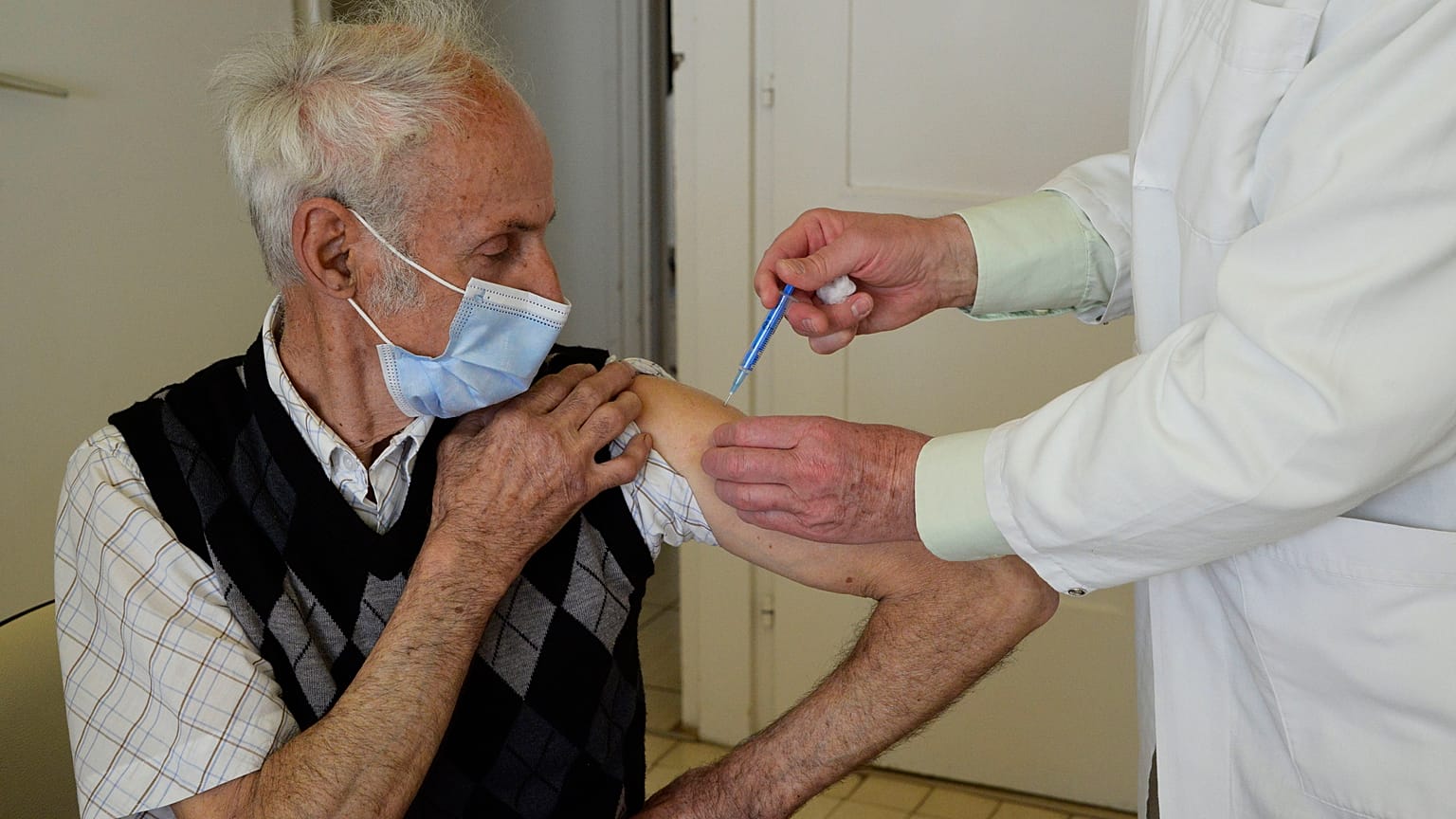 A doctor vaccinates a patient with the second dose of COVID-19 vaccine produced by Chinese Sinopharm in Taplanszentkereszt, Hungary, April 1, 2021