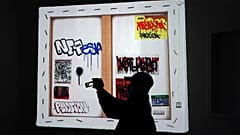 A man views artwrok at the Superchief Gallery NFT, a physical gallery dedicated exclusively to NFT (non-fungible tokens) artwork in New York.