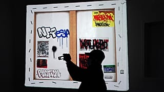 A man views artwrok at the Superchief Gallery NFT, a physical gallery dedicated exclusively to NFT (non-fungible tokens) artwork in New York.