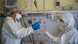 Ápolónő asszisztál egy orvosnak az Országos Korányi Pulmonológiai Intézet koronavírussal fertőzött betegek fogadására kialakított intenzív osztályán 2021. február 18-án. 