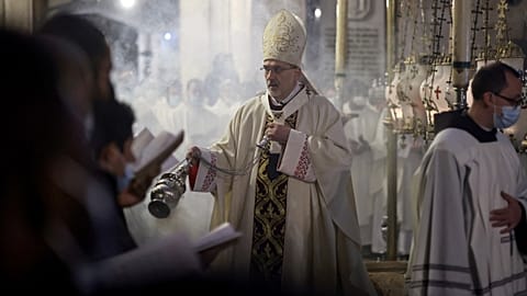 Latin Patriarch of Jerusalem Pierbattista Pizzaballa burns incense around the Stone of Anointing, the place believed to be where Jesus Christ's body was laid.
