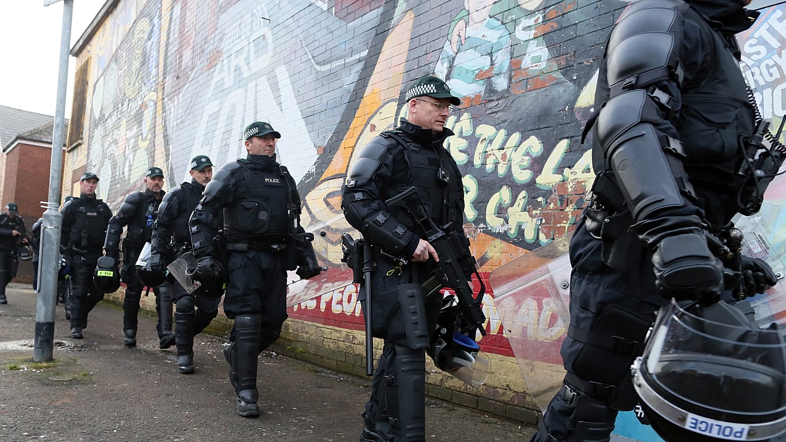 FILE: Riot police leave the area after policing a parade by the unionist Orange Order at the Ardoyne shops on the Crumlin Road in north Belfast on October 1, 2016.