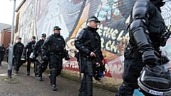 FILE: Riot police leave the area after policing a parade by the unionist Orange Order at the Ardoyne shops on the Crumlin Road in north Belfast on October 1, 2016.