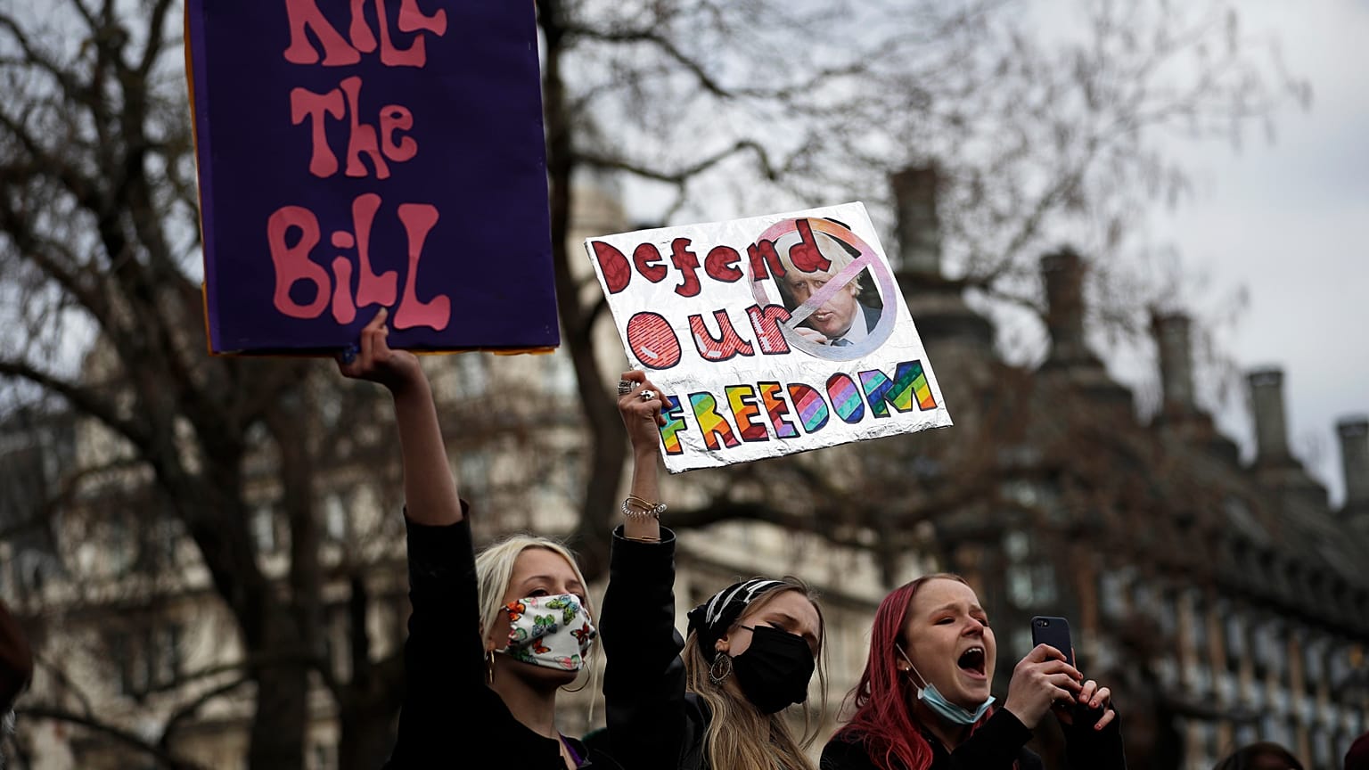 Demonstrators hold posters during a 'Kill the Bill' protest in London, Saturday, April 3, 2021.