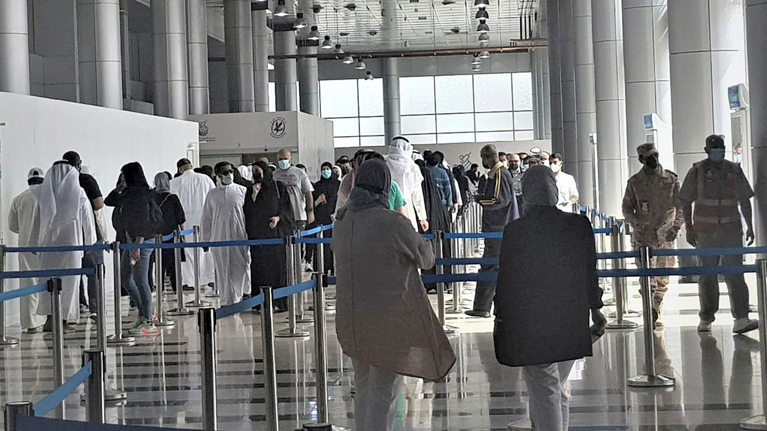 People stand in line at Kuwait Vaccination Centre to get the vaccine in Kuwait.