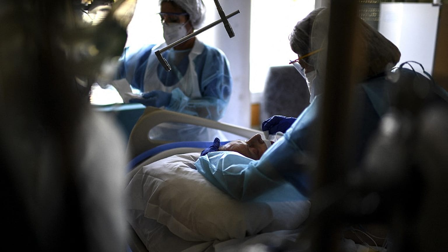 Nurses tend to a Covid-19 patient under respiratory assistance lying unconscious in the intensive care unit of the Hopital Prive hospital in Antony, France, April 2, 2021.