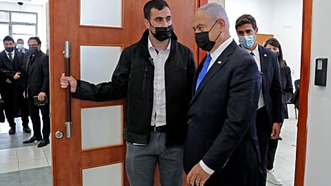 Israeli Prime Minister Benjamin Netanyahu leaves the courtroom at district court in Jerusalem, during his corruption trial. 