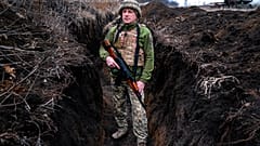 A Ukrainian serviceman, who asked to be identified only by his call sign, Kram, stands at his post in the town of Krasnohorlivka, eastern Ukraine, Friday, March 5