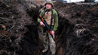 A Ukrainian serviceman, who asked to be identified only by his call sign, Kram, stands at his post in the town of Krasnohorlivka, eastern Ukraine, Friday, March 5