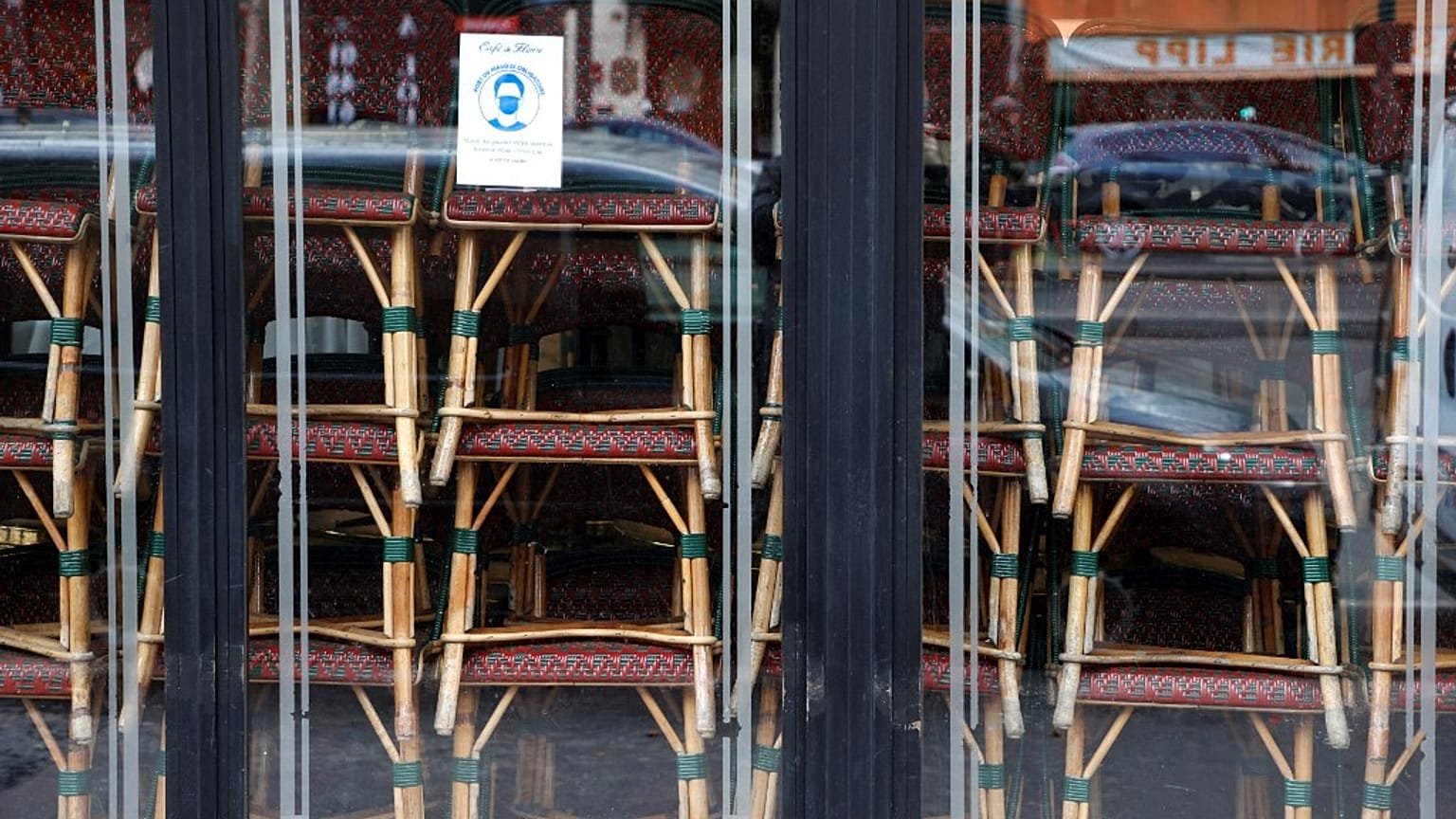 FILE: Chairs are stacked inside the famous Cafe de Flore closed along with all cafes and restaurants, Paris, France, March 15, 2021 