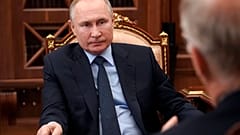 Russian President Vladimir Putin listens to General Director of the Russian Direct Investment Fund Krill Dmitriev at the Kremlin in Moscow, Russia, Friday, April 2, 2021. 