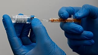 FILE: A doctor prepares the AstraZeneca vaccine at a Pharmacy in Edgeware, London, Tuesday, March 16, 2021. 