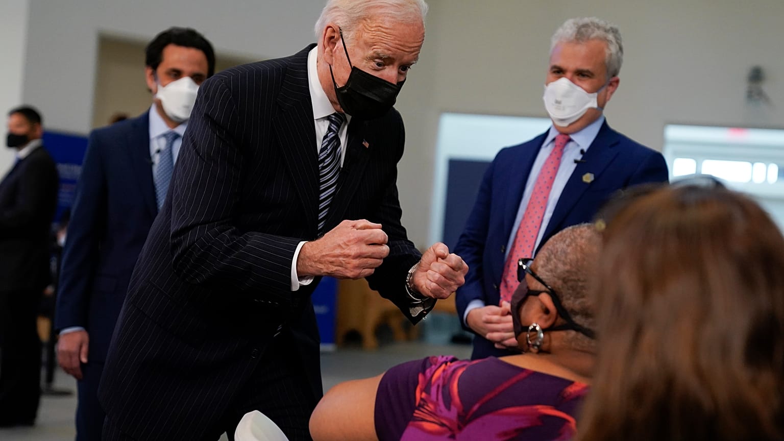 President Joe Biden talks to a person receiving a COVID-19 vaccination shot as he visits a vaccination site at Virginia Theological Seminary, Tuesday, April 6, 2021.