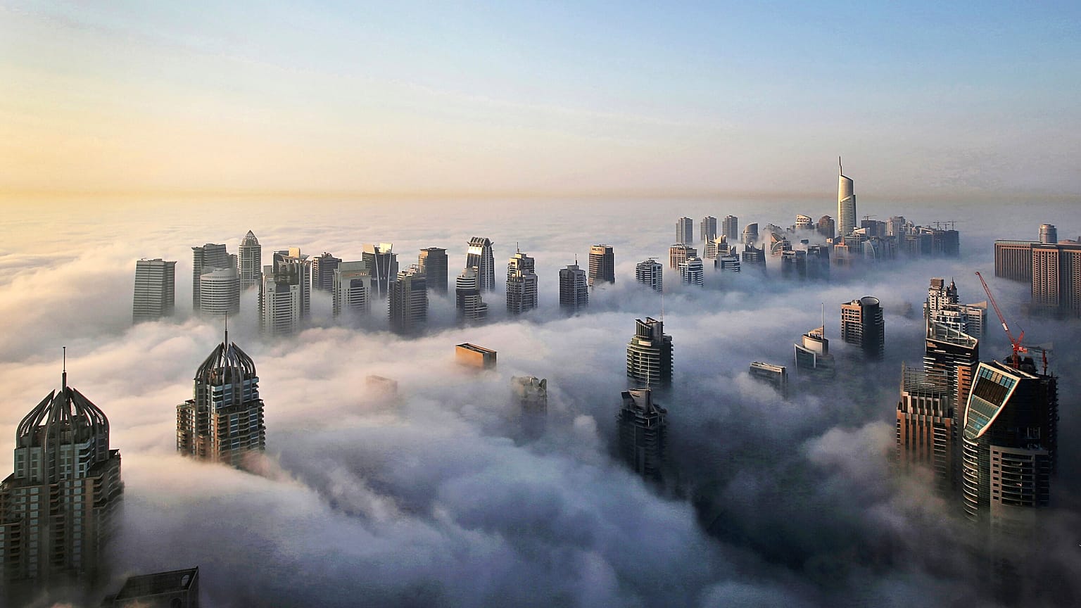In Oct. 5, 2015 file photo, a thick blanket of early morning fog partially shrouds the skyscrapers of the Marina and Jumeirah Lake Towers districts of Dubai.