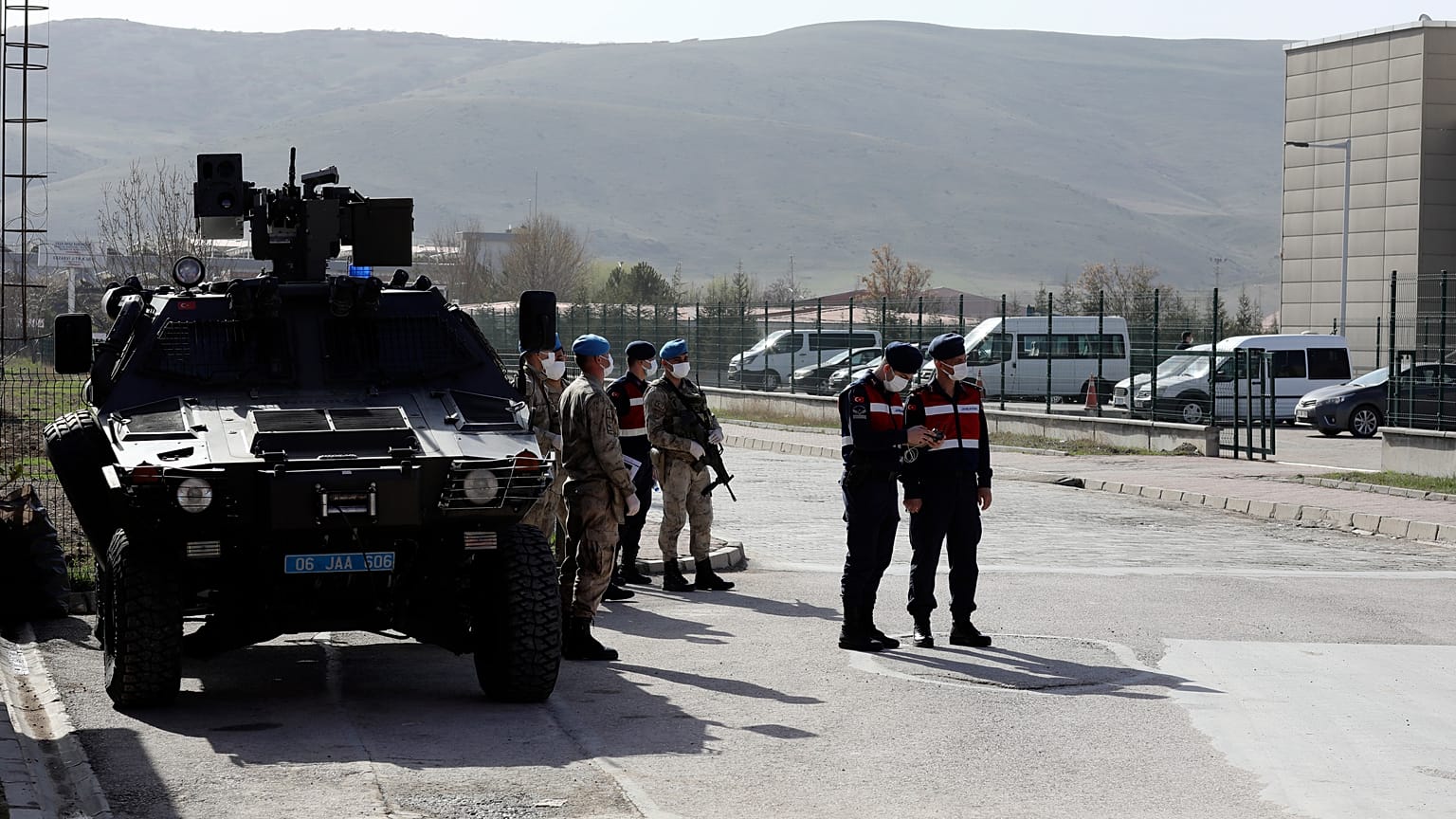 Soldiers stand guard outside the courthouse where 497 defendants are on trial over the failed coup.