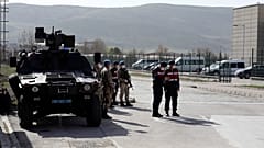 Soldiers stand guard outside the courthouse where 497 defendants are on trial over the failed coup.