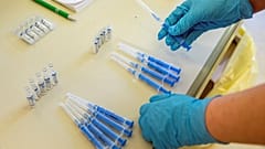 A health worker readies vials of Russia's Sputnik V vaccine