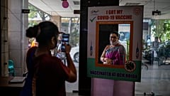 A woman poses for a photograph behind a cutout after receiving a COVID- 19 vaccine at a government hospital in Noida, a suburb of New Delhi, India, Wednesday, April 7, 2021.