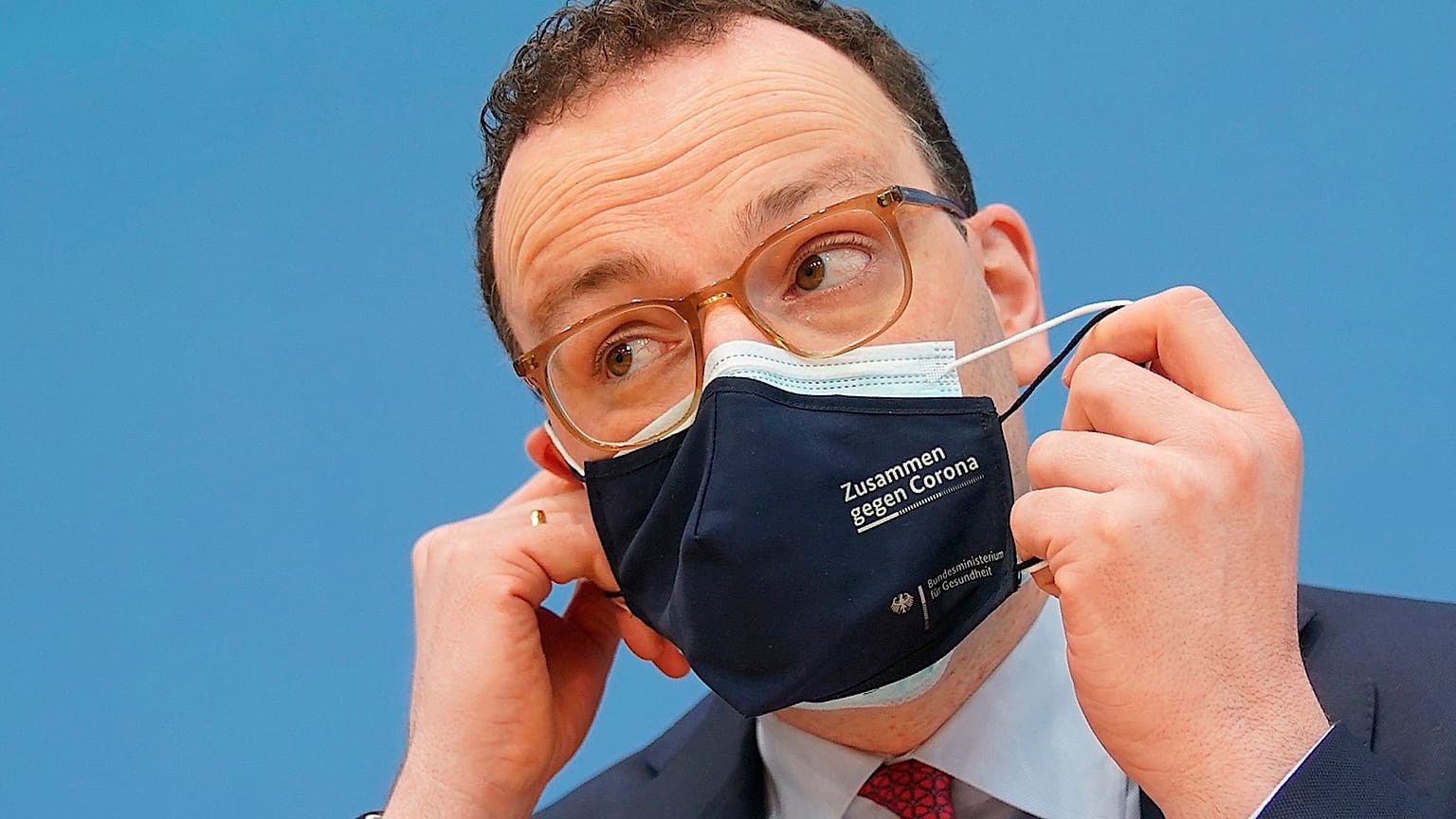 Jens Spahn, Federal Minister of Health, takes off his mouth-nose protection at the Federal Press Conference in Berlin, Germany, Thursday, April 1, 2021.