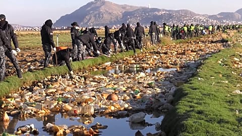 Pan of plastics and other trash piled up on lake