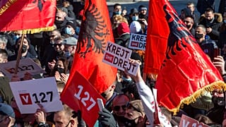 Supporter of VETEVENDOSJE (Self-Determination) political party holds a slogan reading in Albanian " All and Straight" during the closing electoral rally in capital Pristina.