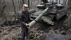 Ukrainischer Soldat untersucht einen Panzer