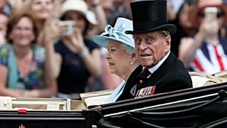 Britain's Queen Elizabeth II and Prince Philip, the Duke of Edinburgh return to Buckingham Palace in a carriage, in London, June 17, 2017.