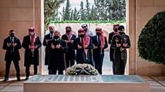 Jordan’s King Abdullah II, center, Prince Hamzah bin Al Hussein, second left, and others visit the tomb of the late King Hussein, in Amman Jordan. April 11, 2021.