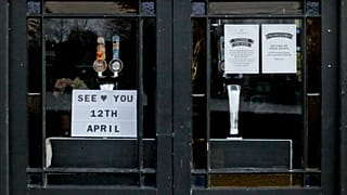 The window of The Rutland Arms pub shows their opening date in Hammersmith, London, Wednesday, April 7, 2021.