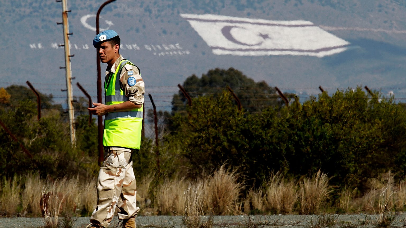 FILE - In this 2014 file photo, a UN peacekeeper stands guard on Pentadaktilos mountain inTurkish occupied northern Cyprus. 