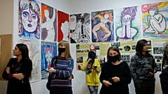 Visitors look at the exhibition of Yulia Tsvetkova's paintings in St. Petersburg, Russia, Saturday, April 10, 2021. 