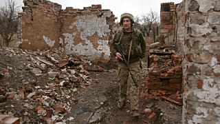A Ukrainian serviceman patrols near the frontline in the fight against Russian-backed separatists near the small city of Marinka, Donetsk region