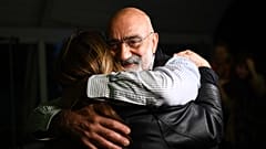 Turkish journalist and writer Ahmet Altan (C) hugs his friends and relatives after being realised briefly on November 4, 2019