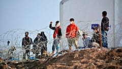 Residents of the temporary camp at Tara Kepe on the Aegean island of Lesbos