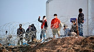 Residents of the temporary camp at Tara Kepe on the Aegean island of Lesbos