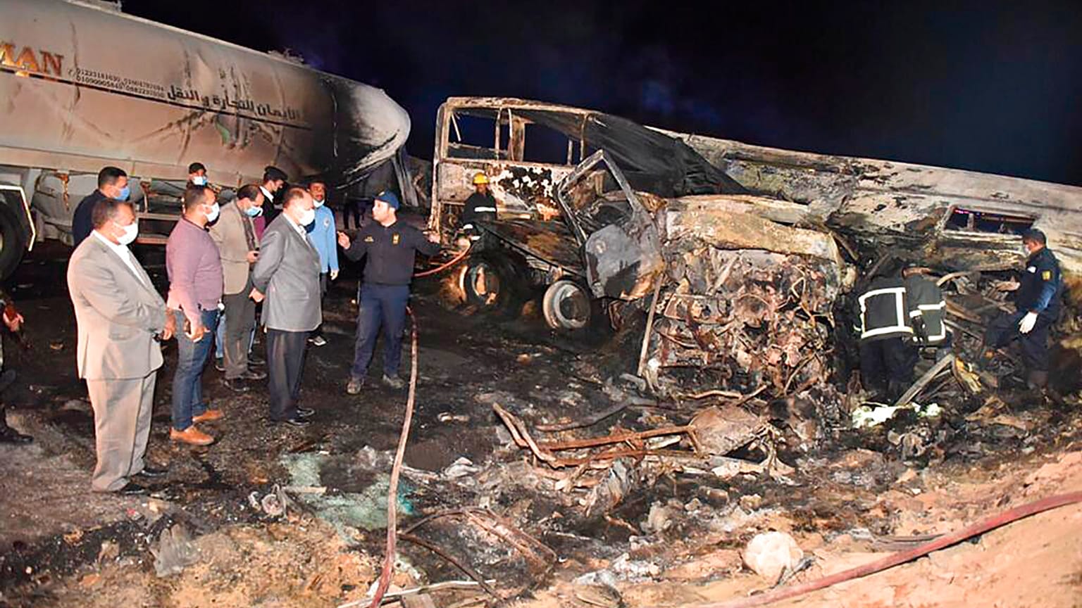 Authorities work on the collision site where a bus overturned, Tuesday