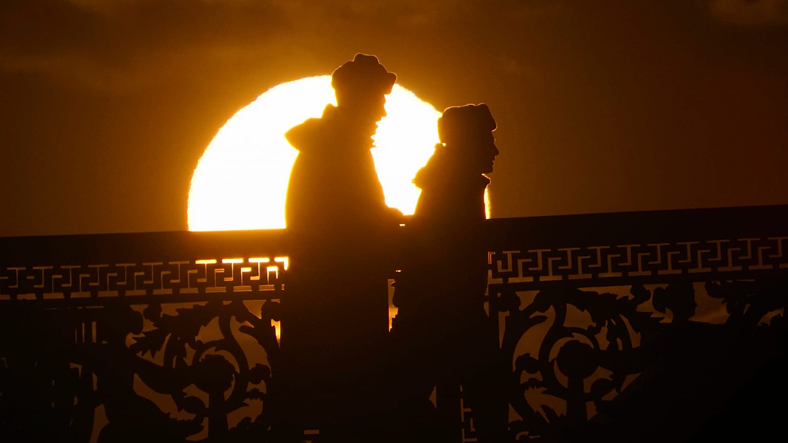 Russian soldiers silhouetted by the setting sun in downtown St. Petersburg, Russia, Friday, March 20, 2020. ((AP Photo/Dmitri Lovetsky)