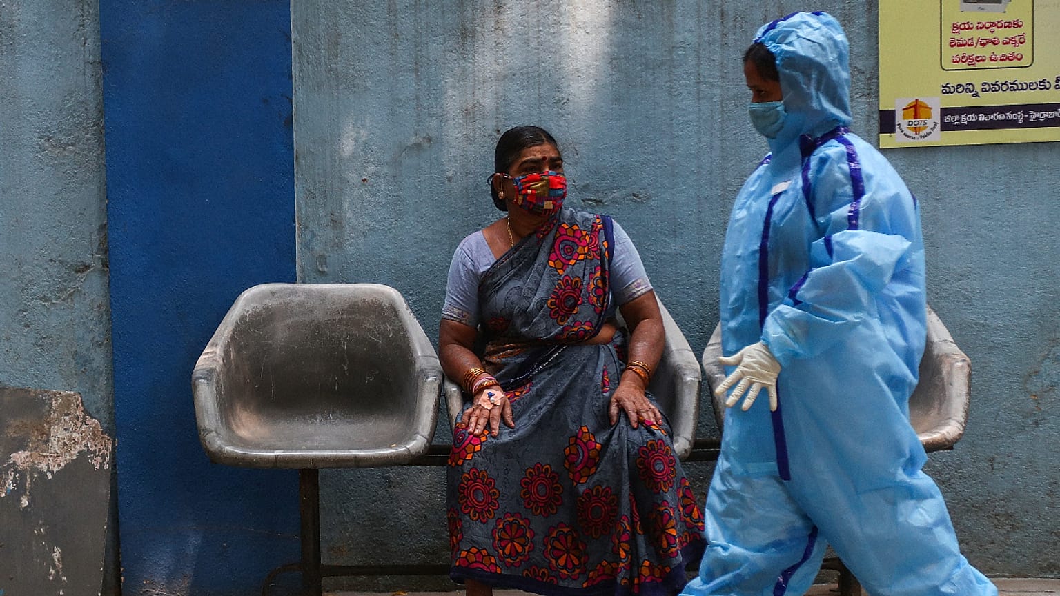 A woman waits to get tested at a COVID-19 testing center in Hyderabad, India, on Wednesday, March 17, 2021. The country is grappling with a rise in COVID-19 infections. 