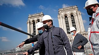 French President Emmanuel Macron visits the reconstruction site of the Notre-Dame cathedral Thursday, April 15, 2021 in Paris