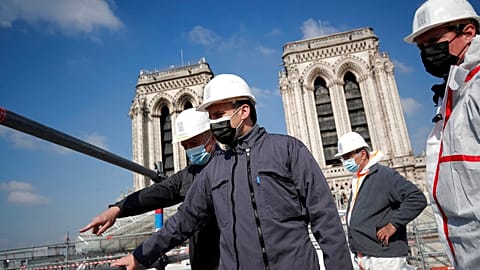 French President Emmanuel Macron visits the reconstruction site of the Notre-Dame cathedral Thursday, April 15, 2021 in Paris