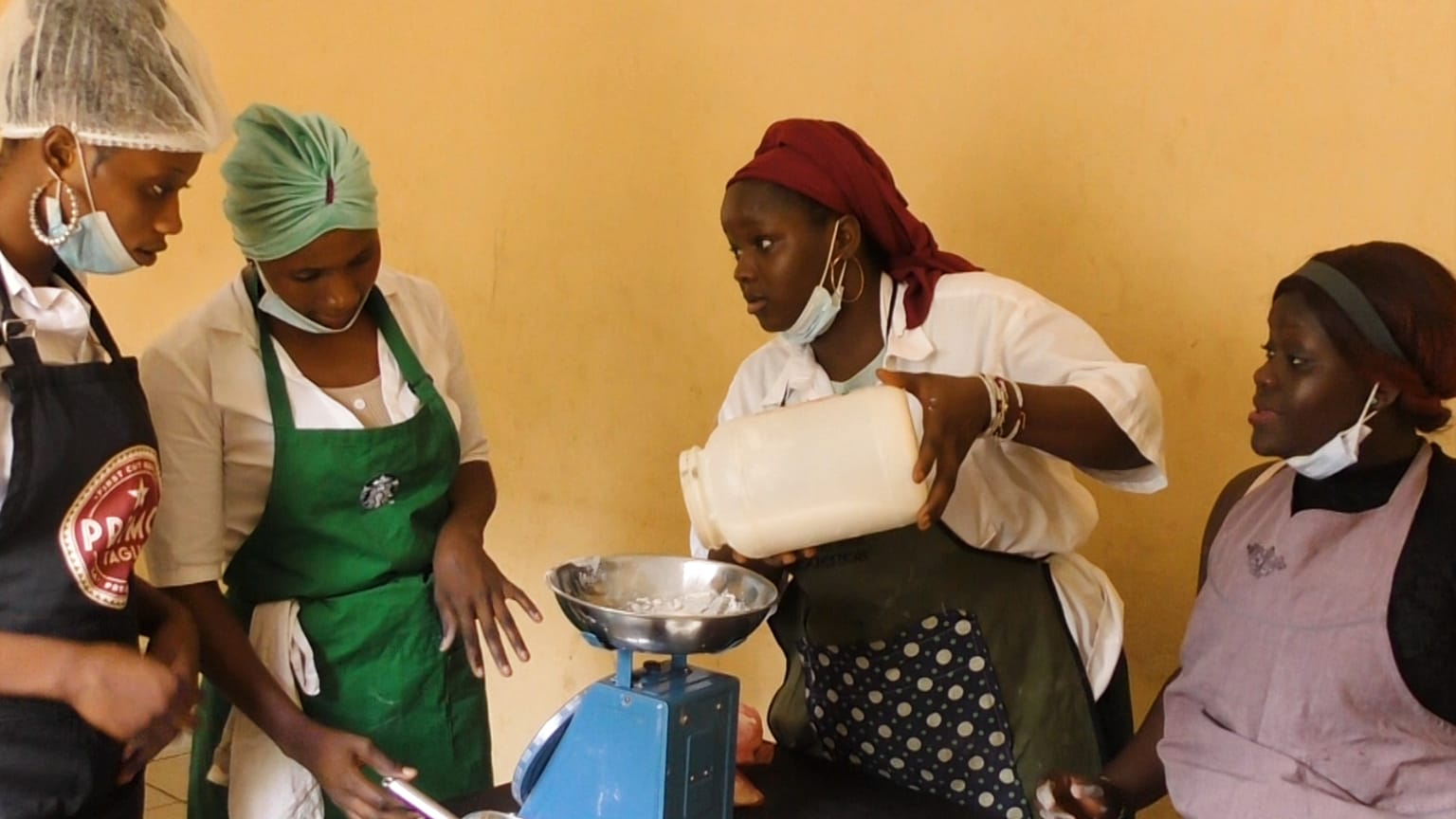 Fatoumata is weighing flour at a baking class in Conakry, Guinea.