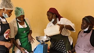 Fatoumata is weighing flour at a baking class in Conakry, Guinea.